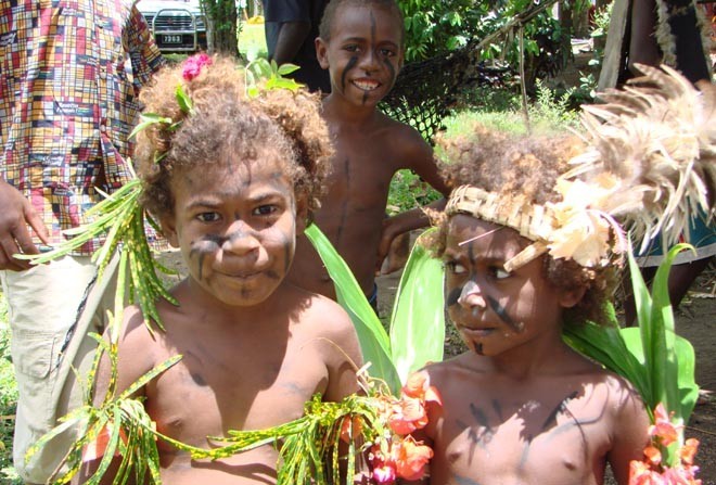Kids in Epule Village dressed up for a traditional ’Custom Dance’ on the shore later in the day. © BW Media